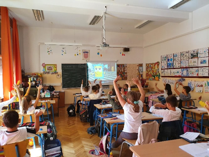 Students in a school class watching a video