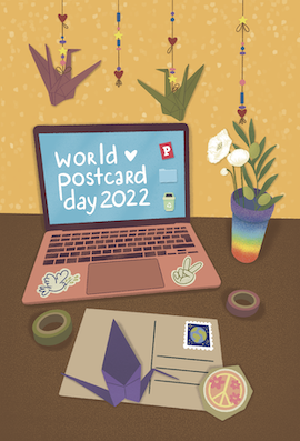 Colorful illustration of a desk with a laptop with the words 'World Postard Day 20022' and peace symbols, surrounded by papercranes. In front of the laptop there's a postcard