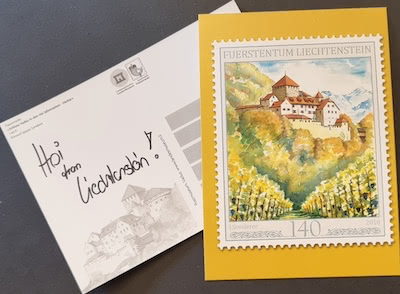 Postcard from Liechtenstein featuring a scenic stamp of a castle and the handwritten note 'Hoi from Liechtenstein!'