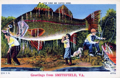 Vintage postcard with the caption 'Greetings from Smithfield, VA,' featuring an exaggeratedly large fish being carried by three people with fishing gear. One person is holding a fishing rod, another is walking with the fish on their back, and a dog is nearby. The postcard humorously reads 'The kind we catch here.'