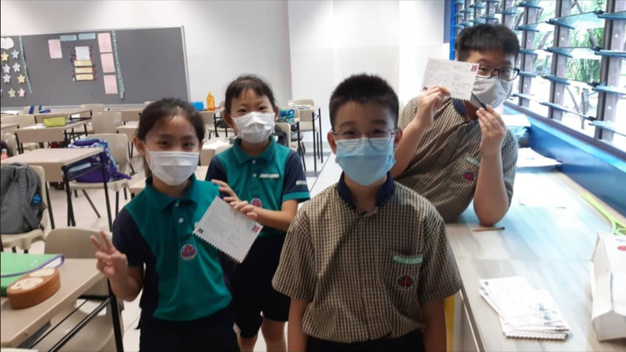 Children in Singapore write their first postcards on World Postcard Day